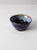 A vintage studio pottery bowl signed by the artist, Margo. The handcrafted ceramic bowl features a layered glaze in navy...