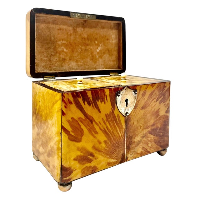 An English faux tortoiseshell box on ball feet. Complete with all original interior, no key. England, circa 1800s to 1820s.