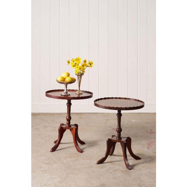 Pair of English mahogany side tables featuring elegant scalloped lips, rich patina, and timeless 1930s craftsmanship
