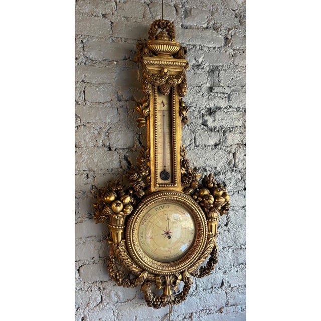 19th-century French giltwood barometer with working thermometer. Well executed carvings of scrolls, swags, and bounty all...