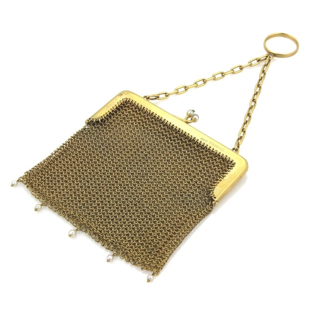 This product is a vintage Victorian-era purse crafted from 9k yellow gold and adorned with pearls. The intricate mesh...