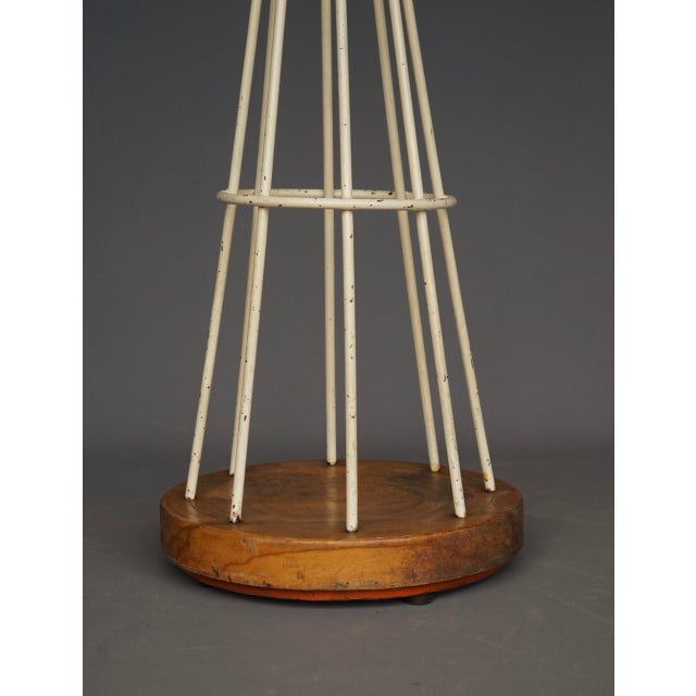 An unusual 1950s coat stand in the manner of Mathieu Mategot. It has a heavy weighted base that supports a painted steel...