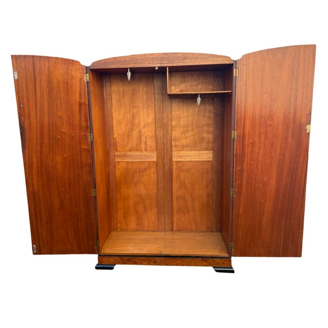 A truly striking Art Deco Double Wardrobe dating to Circa 1930. The doors are veneered like a Collage of specimen burr...