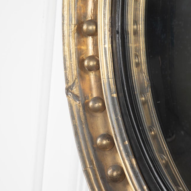 An excellent example of regency carved gilt wood convex mirror by thomas fentham, with acanthus, foliate and scrolled...