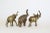 Set of three brass elephant with truck up these elephant have vintage patina Dimensions; 5" Width x 2" Depth x 5" Height...