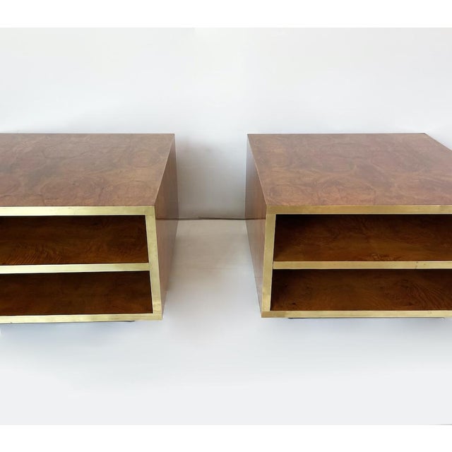 An elegant pair of bedside tables crafted entirely from elm burl with brass front lighting. Featuring two large open...