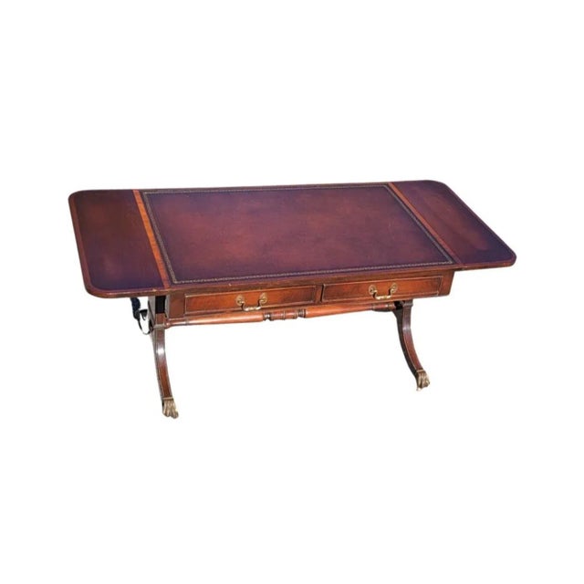 A George III Style Mahogany And Leather Top Inset Drop Leaf Coffee Table in good vintage condition. Two drawers on one...