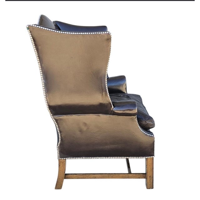 Vintage Dark Brown leather George III style wingback armchair with classic nail head trim, rolled arms, and dramatic high...