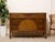 A handsome vintage dresser with strong Art Deco influence, featuring a broad low-profile case, decorative geometric veneer...