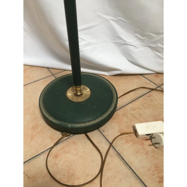 Empire style floor lamp. Partially covered with green dyed leather with a golden Empire pattern, slight damage as seen in...