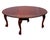 Folding mahogany dining table made in the mid-20th century. Round shape with foldable side wings. Hand-carved legs with...
