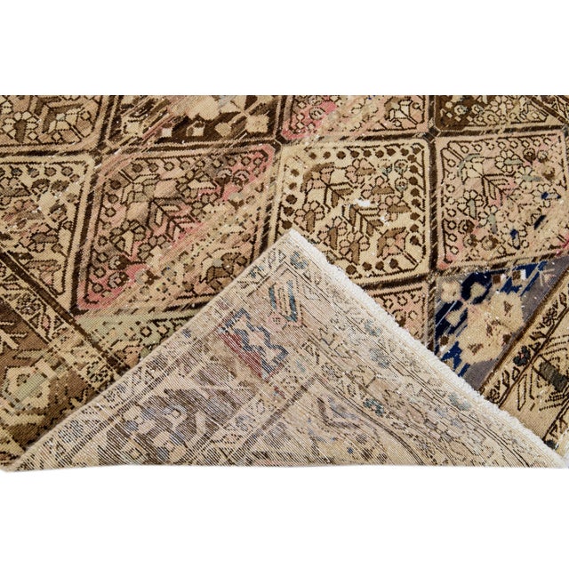 Beautiful Vintage Floral hand-knotted wool rug with a beige field. This rug has blue, pink and tan accents all-over a...