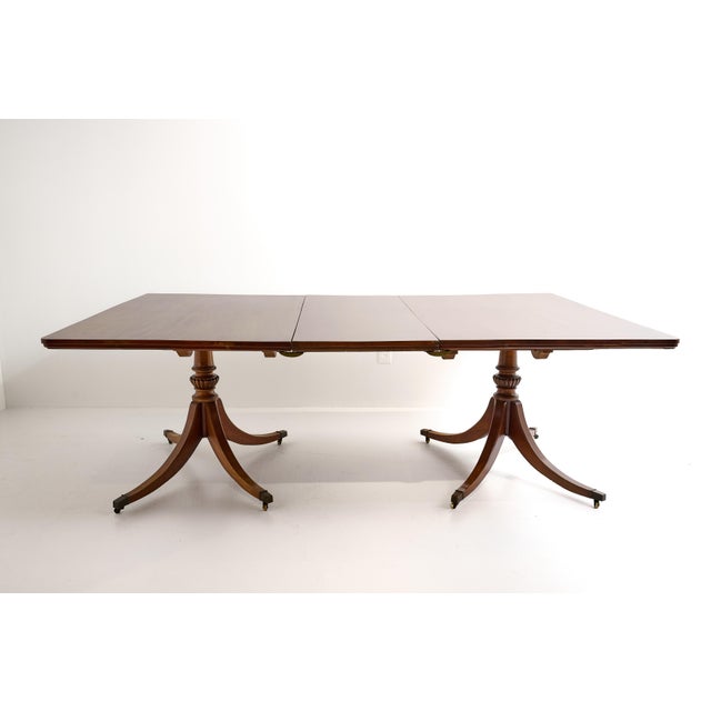 A fine quality early 20th Century English Georgian style dining table of faded mahogany with the top and leaves of solid...