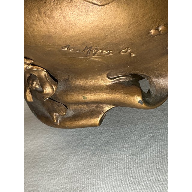 In the Art Nouveau style of the 19th and early 20th Century, this is an outstanding oval bronze colored cupid design...