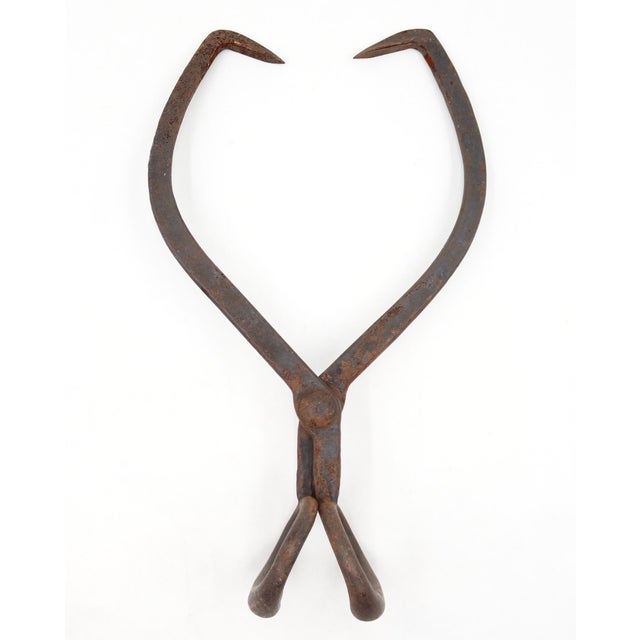 Antique heavy duty tongs designed for delivery men to grip and transport large blocks of ice from wagons into residential...