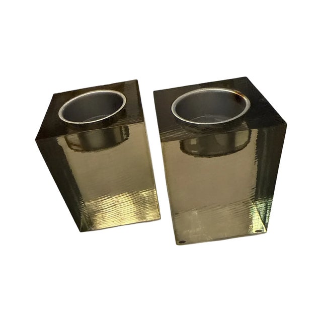 A sculptural pair of modern cube candle holders featuring a strong architectural form. Each piece is made from smoky...