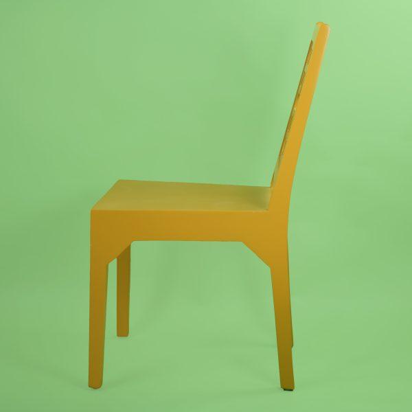 A fretwork desk chair newly lacquered in a cheerful mustard finish, with an open geometric back that keeps a desk or...