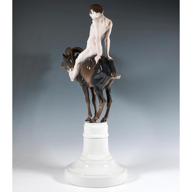Admirable art nouveau group of figures by rosenthal: naked faun-like boy sitting on the back of an ibex, straining his...