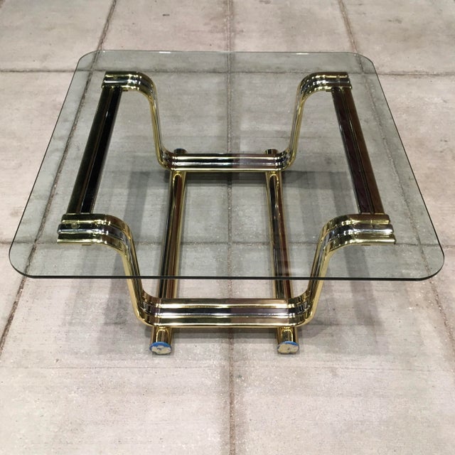Vintage chrome and gold metal bent tubular form based coffee table with heavy glass top Romeo Rega style likely by design...