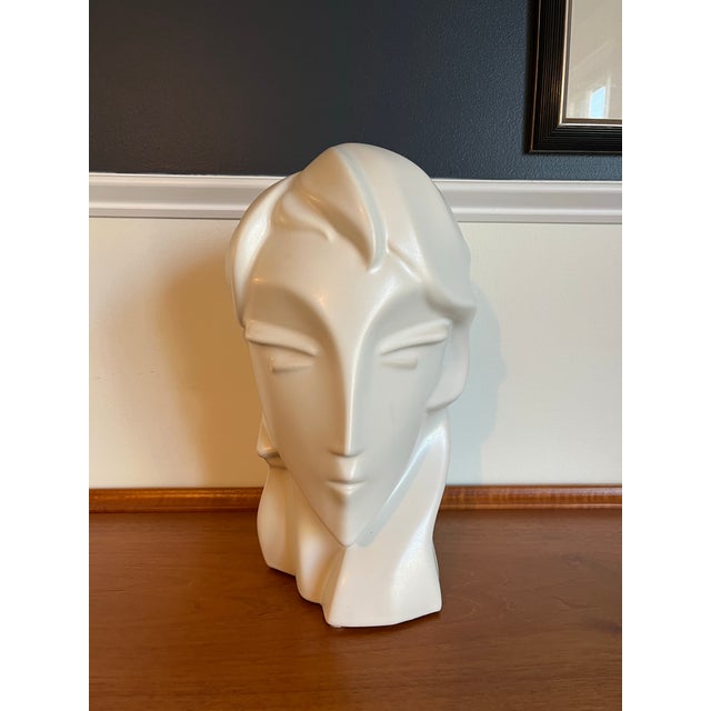 Sculptural ivory-colored bust by Harris Potteries, featuring an elongated face, almond-shaped eyes, and sweeping, stylized...