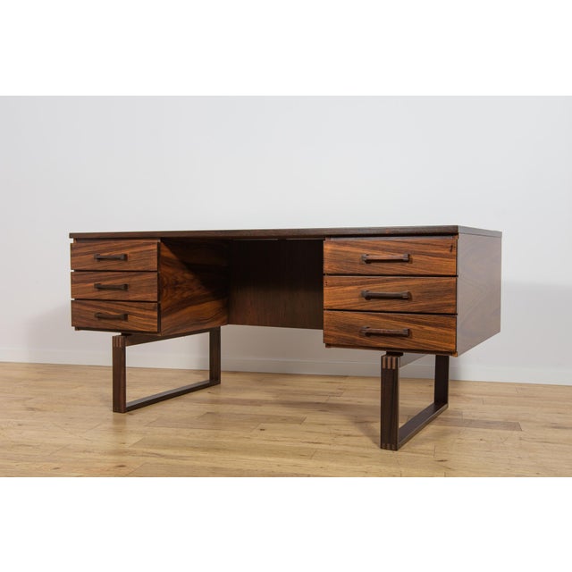 This freestanding desk was designed by Henning Jensen and Torben Valeur for the Danish furniture manufacturer Dyrlund...