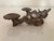 A pair of antique small iron dragon-form Chinese chop stick supports or rest with a curling serpentine body, stylized...