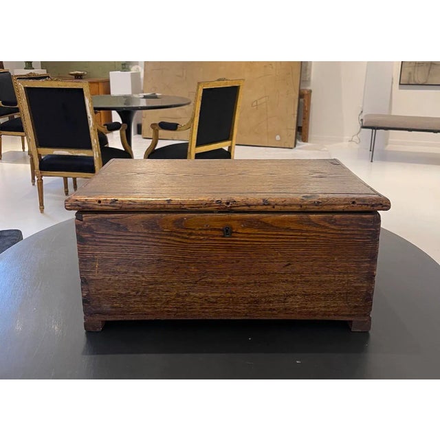 Antique Primitive Wooden Chest with Original Iron Hardware A beautifully aged primitive wooden chest distinguished by its...