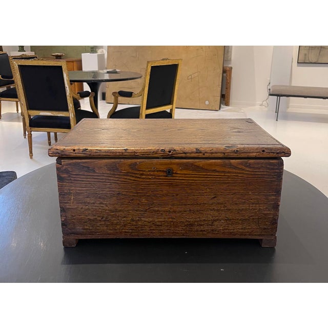 A beautifully aged primitive wooden keepsake box with rich patina and understated character, embodying the timeless appeal...