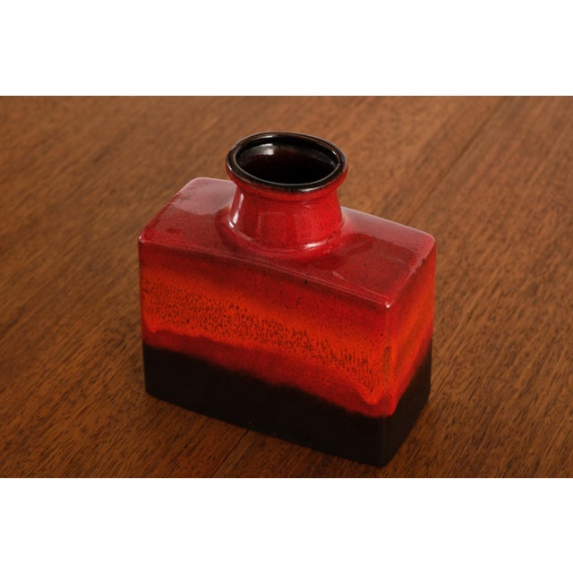 A square body with a rounded neck, already an interesting conversation, finished in a two-tone glaze that bleeds from deep...