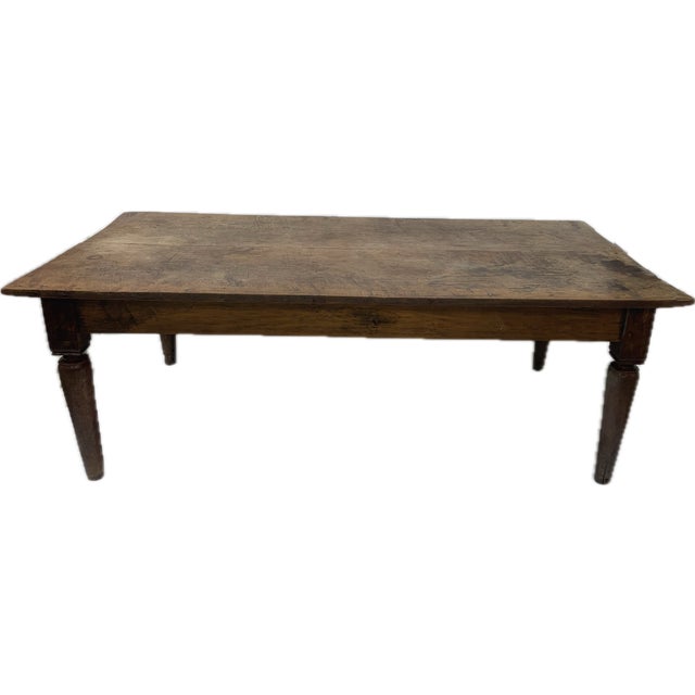 A beautifully aged 19th-century Scandinavian farm table crafted from solid oak, showcasing the timeless character and...