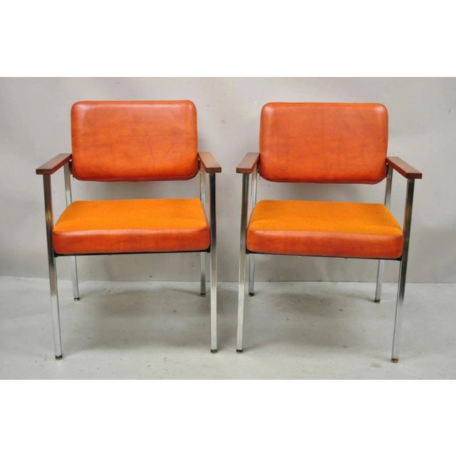 Vintage Mid Century Modern Orange Naugahyde Chrome Frame Arm Chairs by Malibu - a Pair. Item features chrome metal frame,...