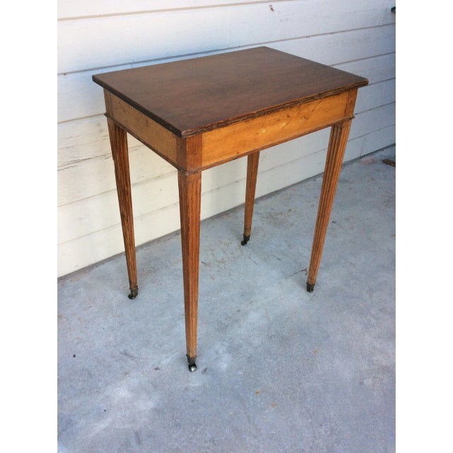 This Early 20th Century English Side Table is constructed of aged English Pine. The piece features four hand grooved...