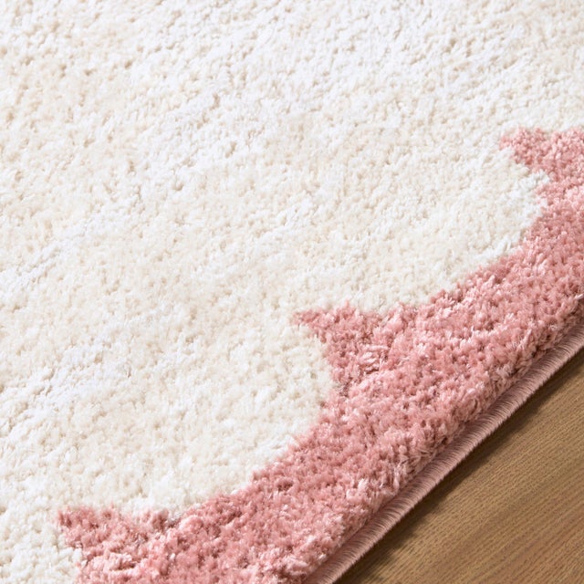 Step into the realm of cozy minimalism with the Fossay Shag area rug, where modern design meets plush comfort. This...
