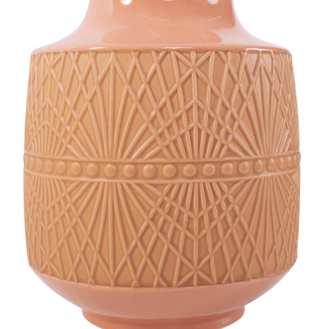 This peach ceramic vase featuring a captivating blend of glossy and matte finishes, is available in three sizes. The...
