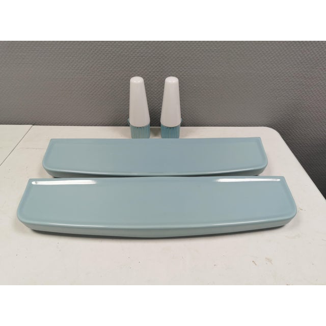 Bathroom lamps with matching shelves in light delicate blue porcelain. Designed by Sigvard Bernadotte for IFÖ Sweden...