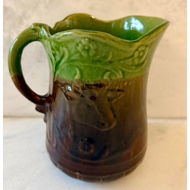 Farmhouse Green and Brown Majolica Pitcher With a Cow and Flowers For Sale - Image 3 of 8