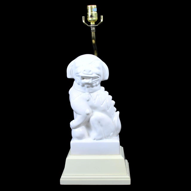 A stately single table lamp modeled as a white Bali foo dog, blending chinoiserie charm with sculptural presence. The...