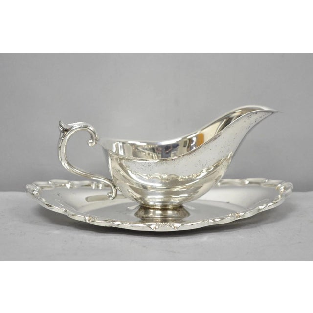 Vintage Victorian Style Silver Plated Gravy Sauce Boat w/ Attached Dish. Circa Mid 20th Century. Measurements: 4" H x 9.5"...