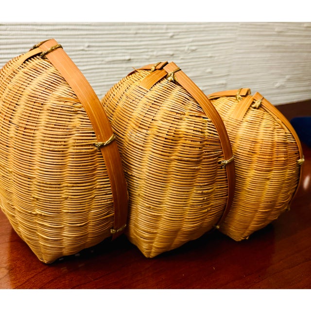RARE vintage handmade rattan wicker nesting baskets. Set of 3. Beautiful color and craftsmanship. Substantial bamboo rim...