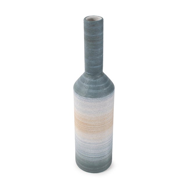 Elegant and refined, this tall bottle vase features a long, narrow neck that adds vertical interest to any display. The...