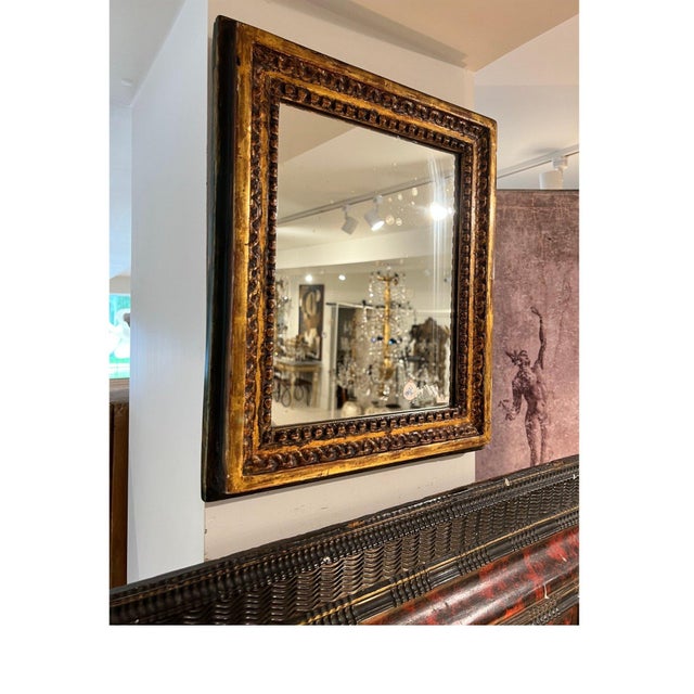 An elegant 18th Century French Louis XVI mirror showcasing the refined symmetry and timeless craftsmanship of the period....