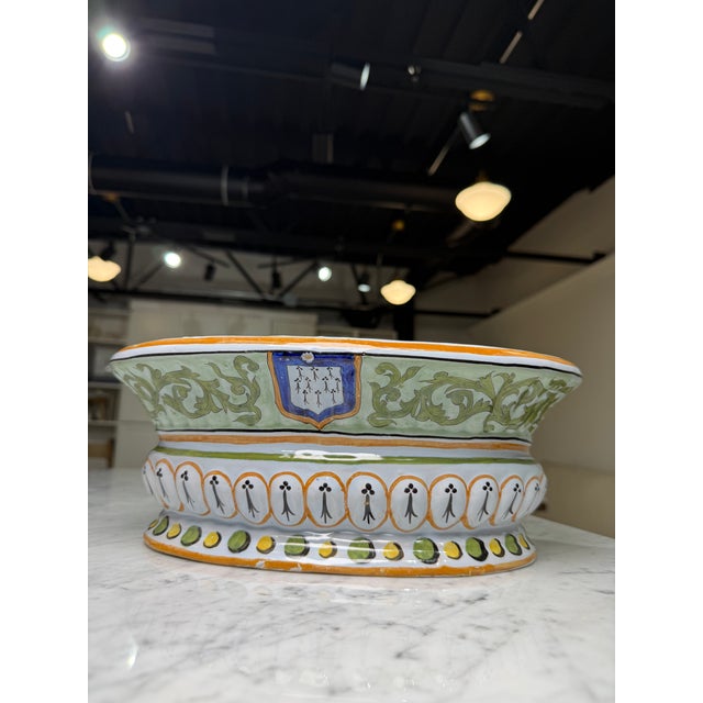 A beautifully hand-painted French faience jardinière in the Quimper tradition, this decorative planter celebrates the rich...