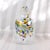 This is a white and multicolor metallic and iridescent art glass perfume bottle. The main bottle is clear and white and it...