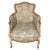 Elegant pair of French Louis XV style bergère chairs featuring gracefully curved frames with a softly distressed painted...