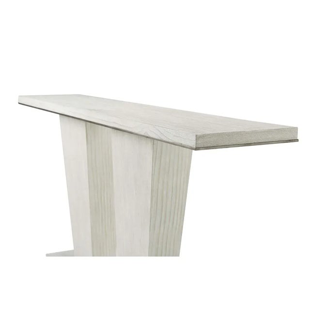 A Modern Coastal Console table, exquisitely crafted from quartered pine highlighted by a double pedestal base and...