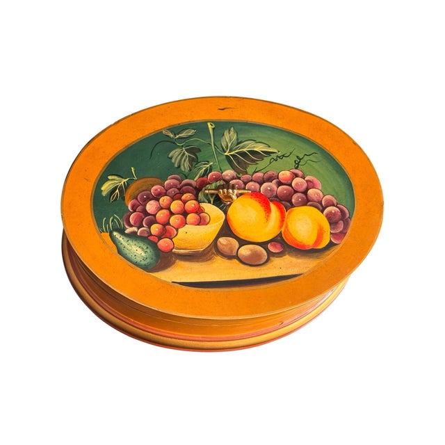 A vintage Maitland-Smith hand-painted wooden oval box. This collectible piece features a classic still-life fruit...