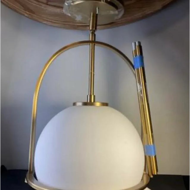 Sophisticated and timeless modern globe pendant lights features frosted glass spheres suspended within elegant brushed...