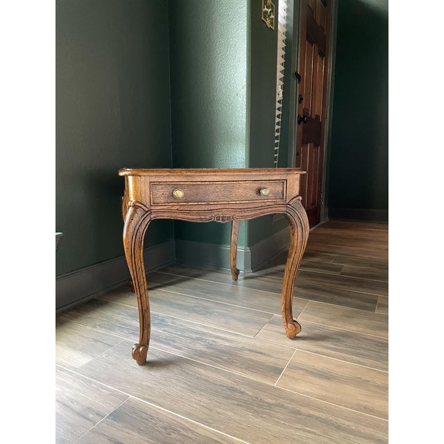 A timeless Century Furniture of Distinction end table featuring a stunning burlwood veneer top framed in walnut and set on...