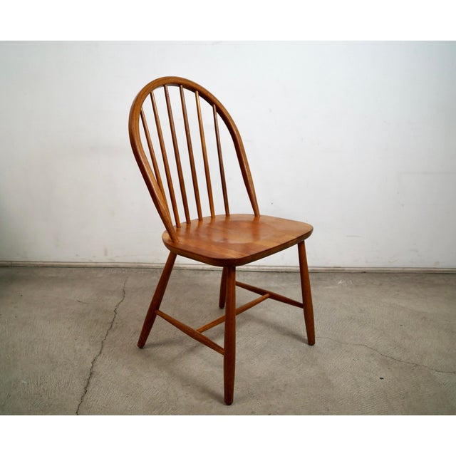Vintage Mid century Danish Modern windsor chair for sale. It's constructed of solid teak, and was manufactured by Tarm...