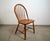 Vintage Mid century Danish Modern windsor chair for sale. It's constructed of solid teak, and was manufactured by Tarm...